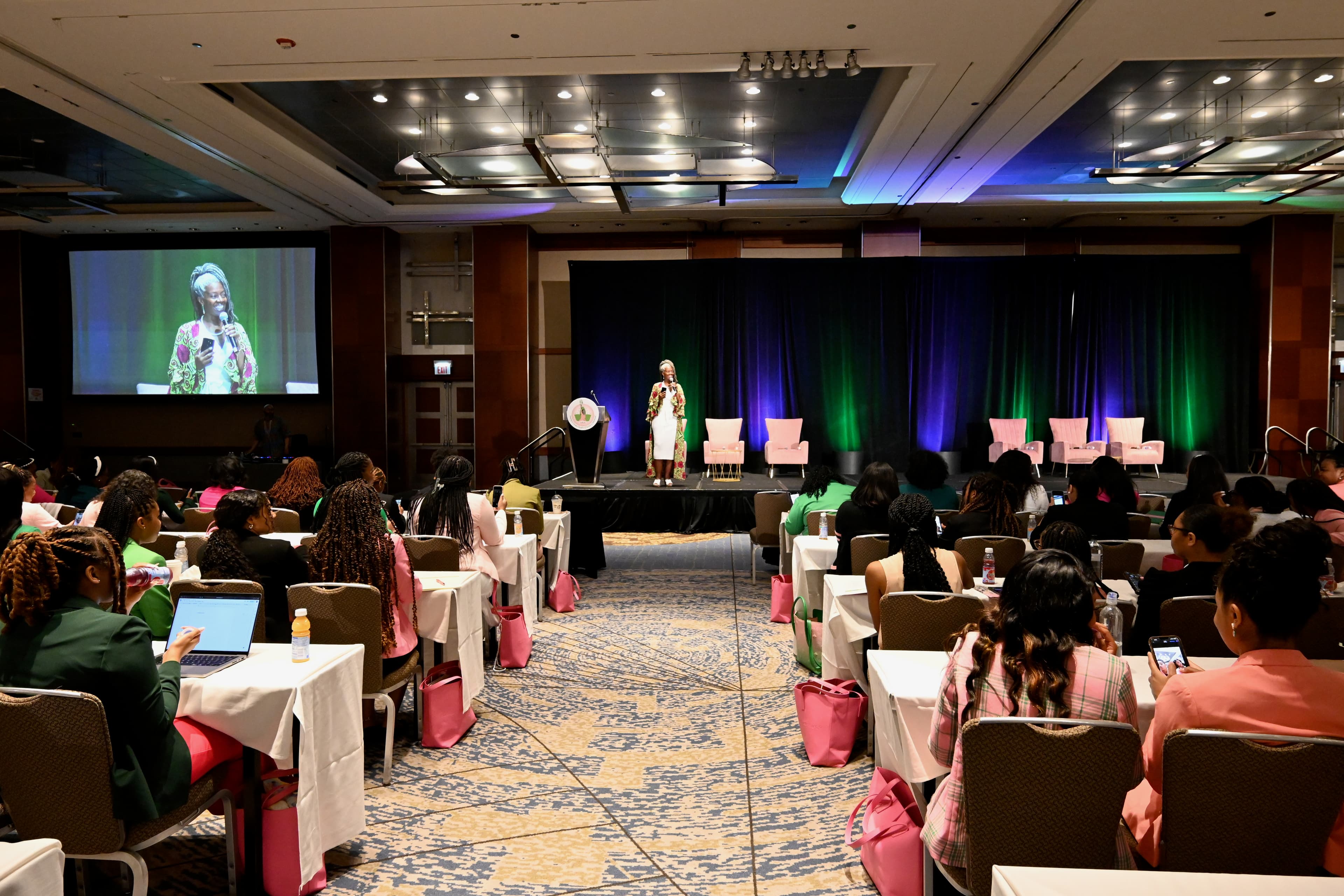 A full audience attentively listening to Althea on stage